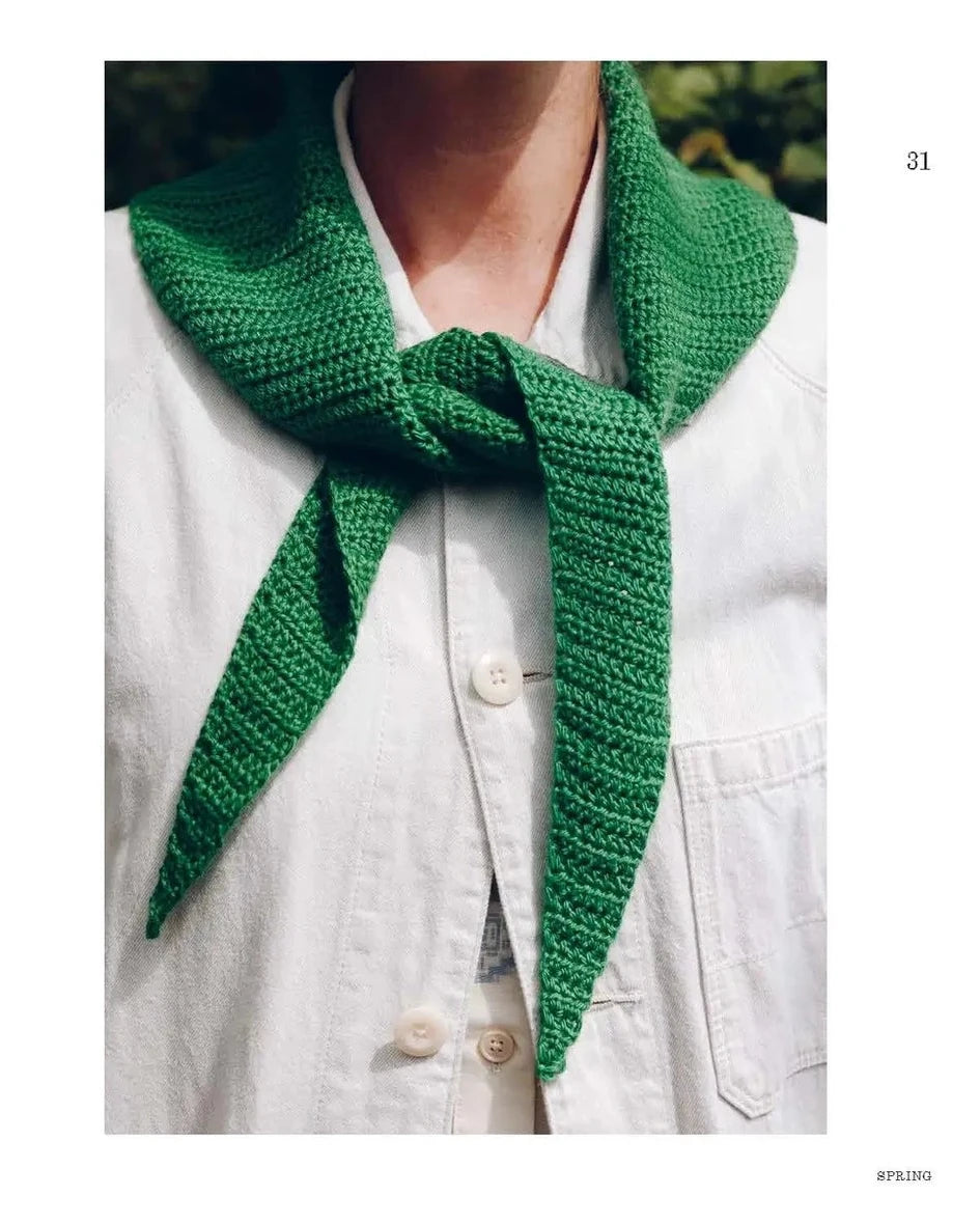 Green knitted neckerchief worn by a person 