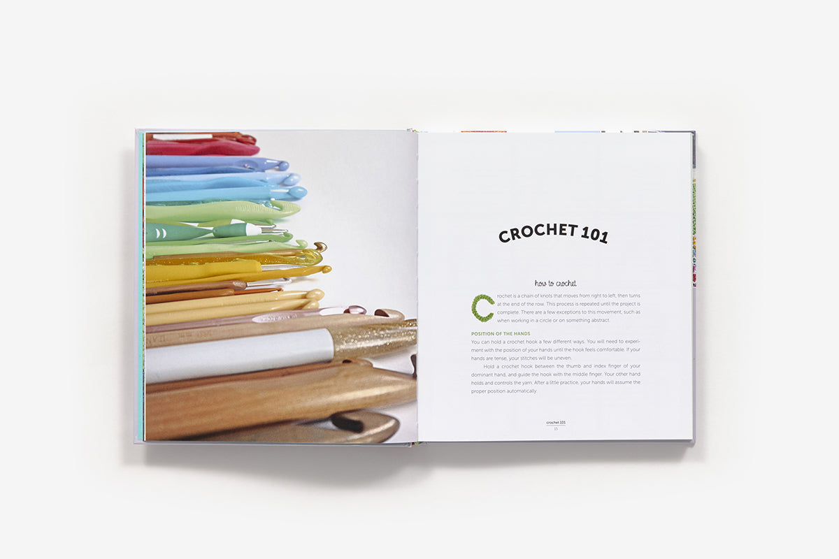 Open book showing colorful crochet hooks and 'Crochet 101' text on a white background