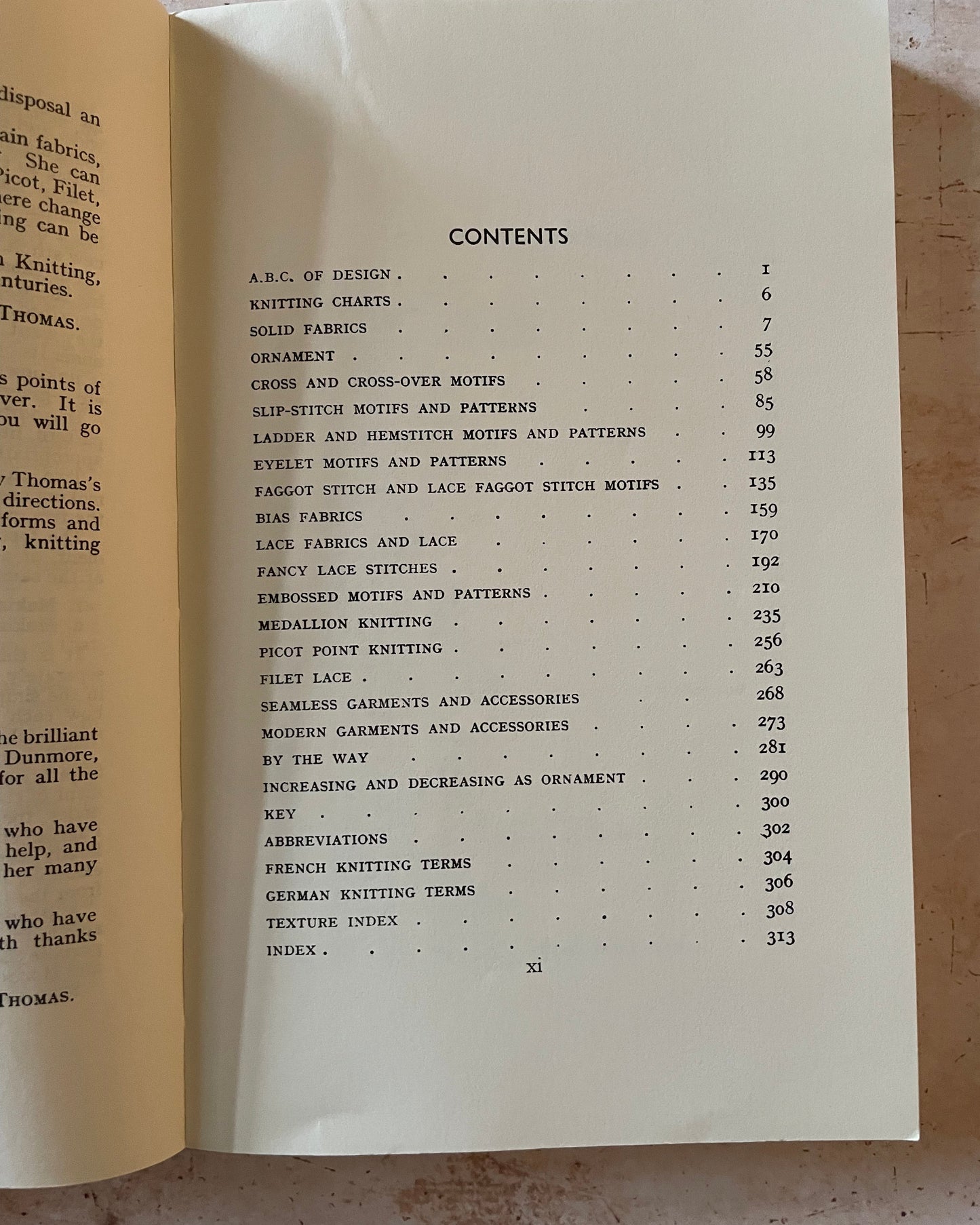 Open book showing a table of contents on a textured surface