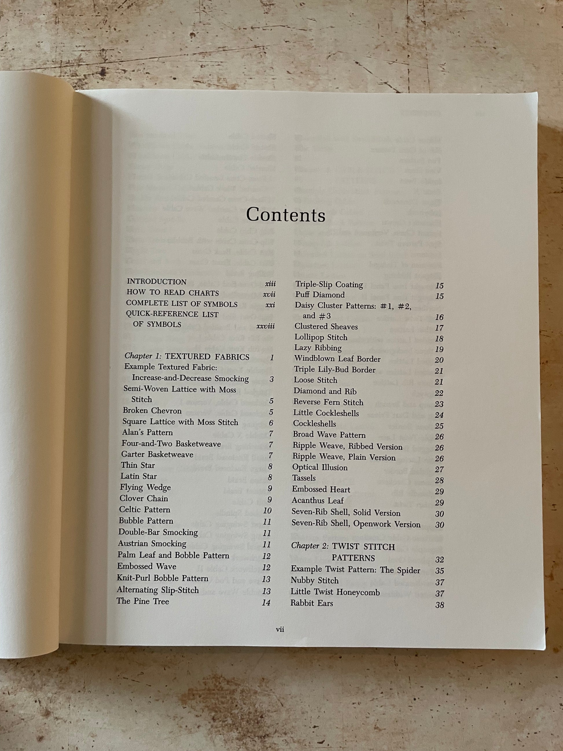 Open book with a table of contents on a textured surface