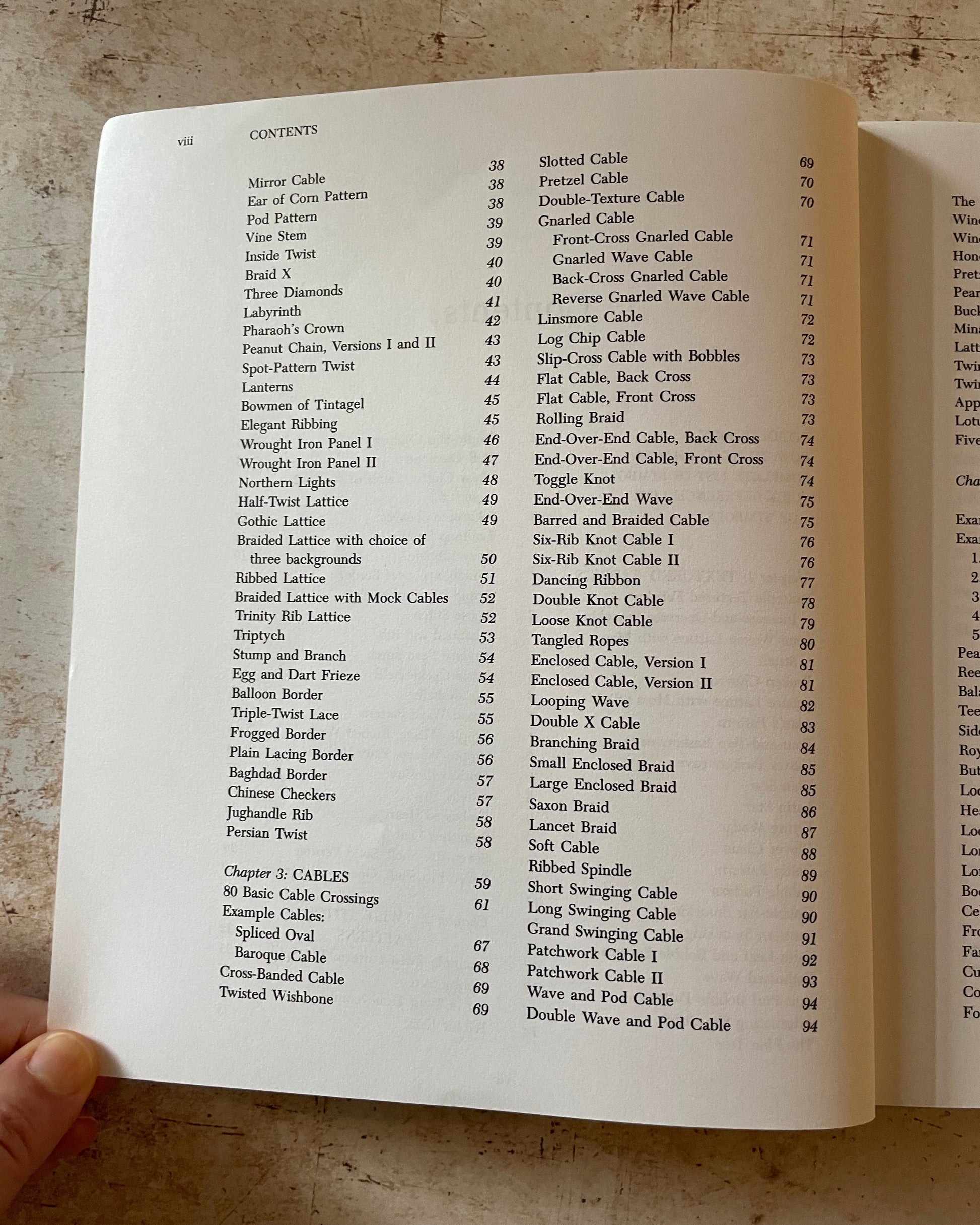 Open book showing a table of contents on a textured surface