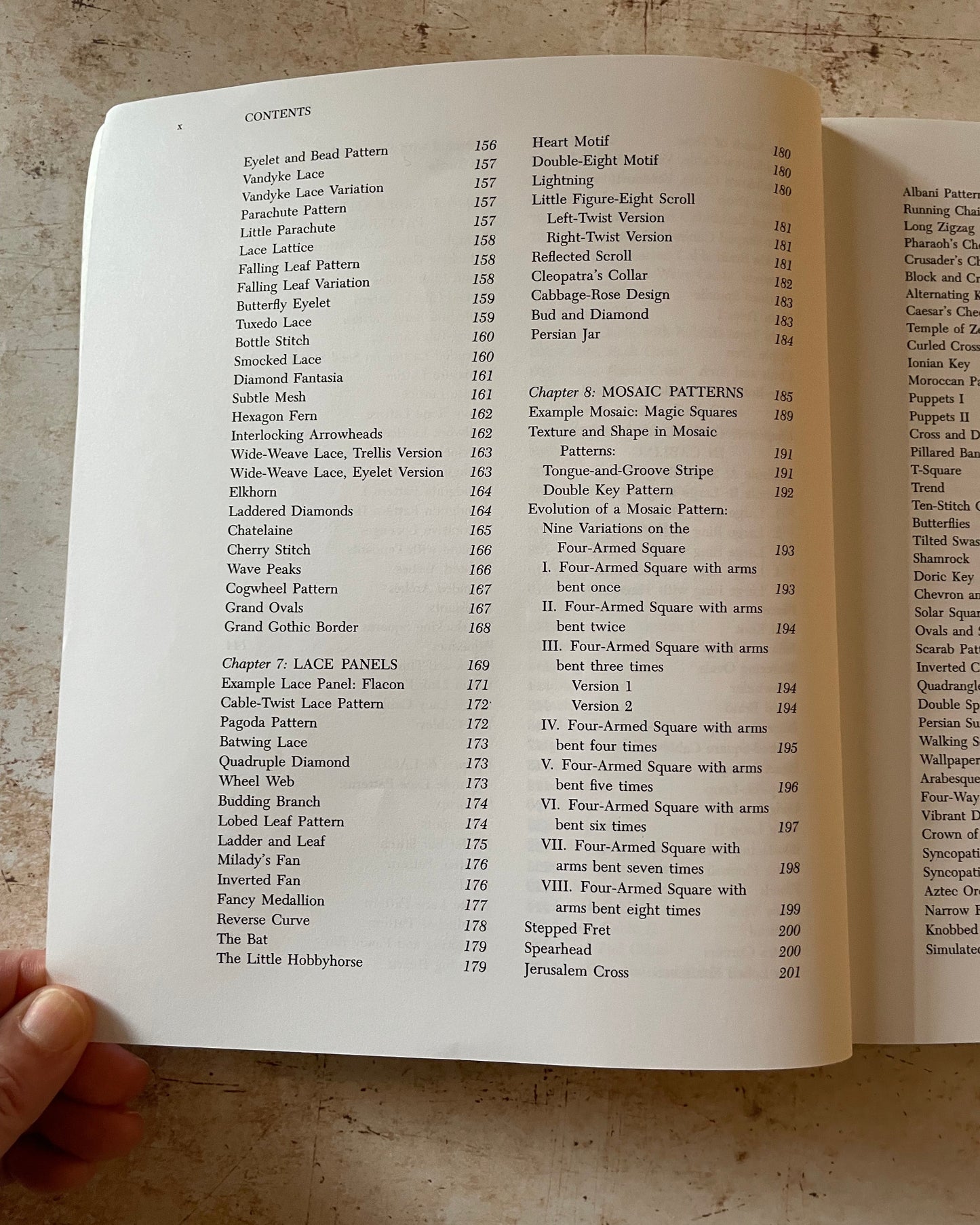 Open book with a table of contents on a textured surface