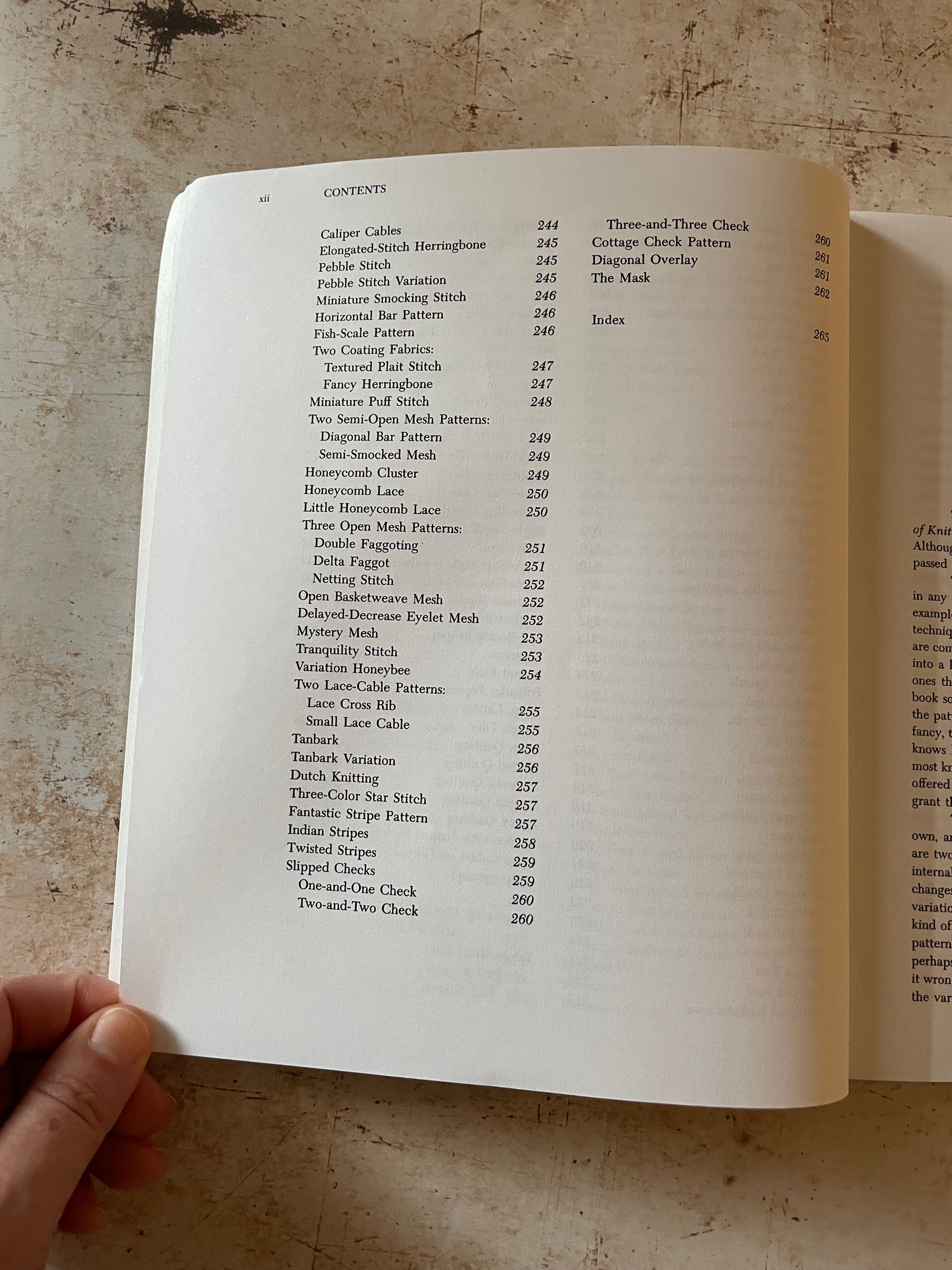 Open book with a table of contents on a textured surface