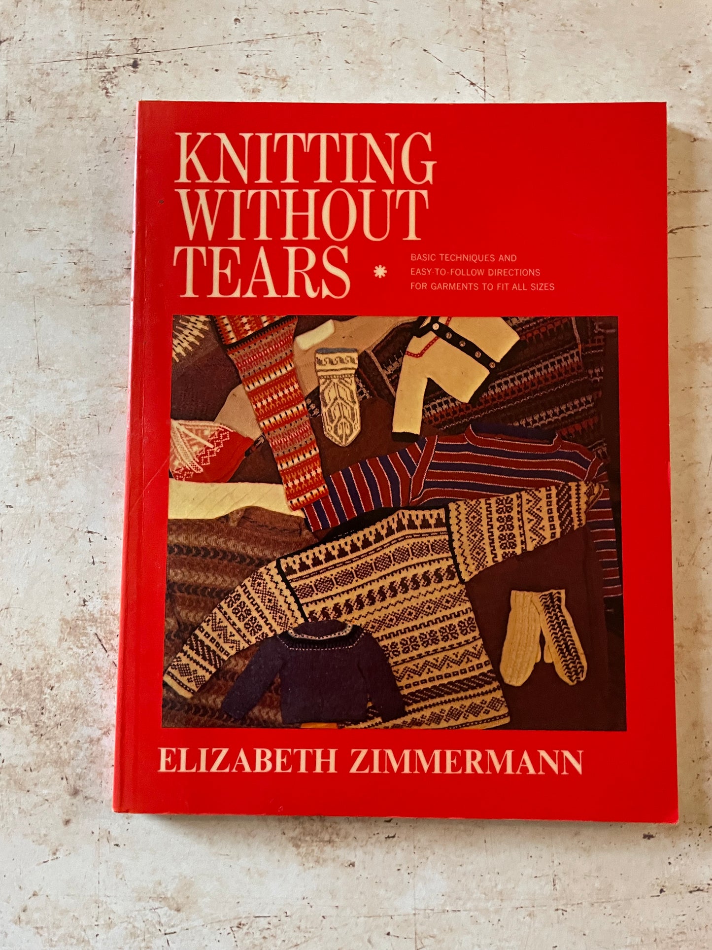 Book titled 'Knitting Without Tears' by Elizabeth Zimmermann on a textured surface