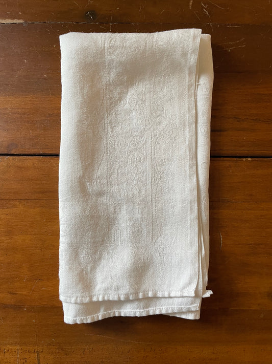 Folded beige cloth on a wooden surface