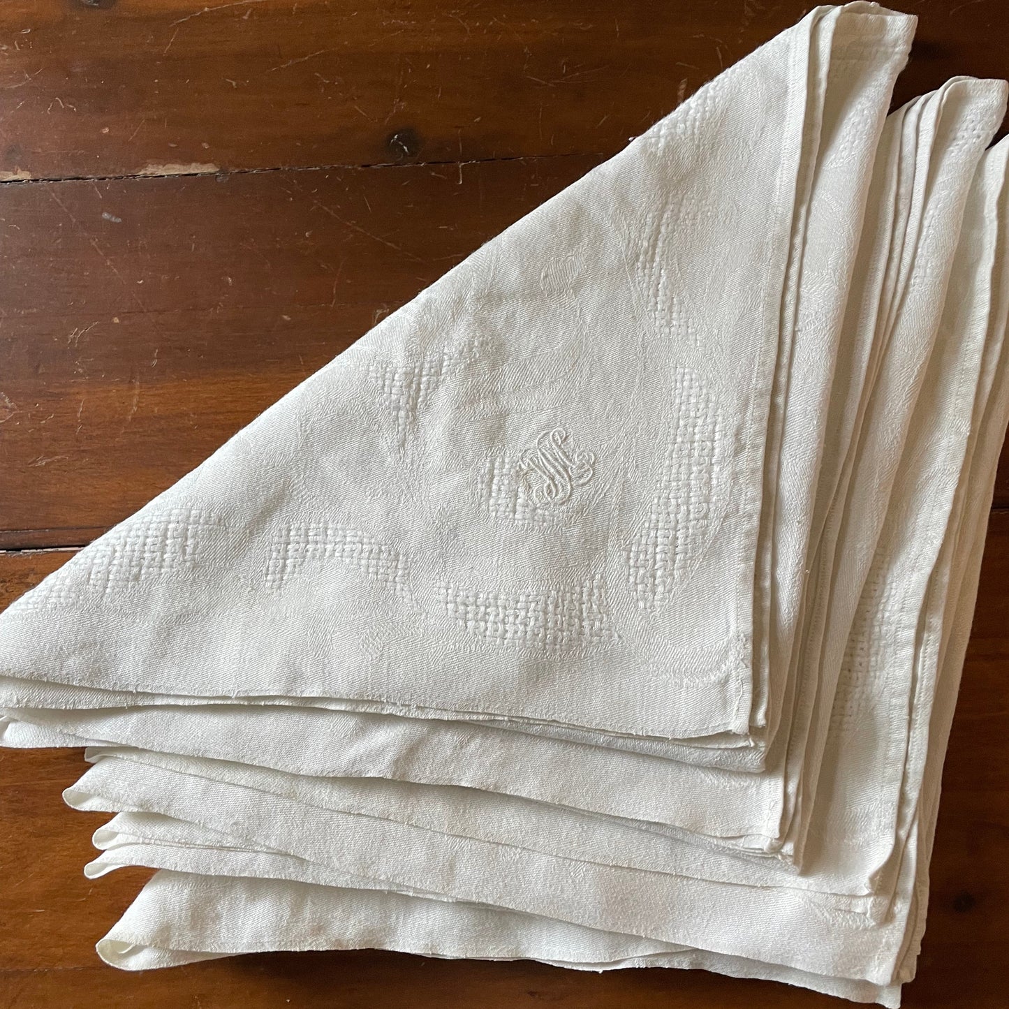 Stack of white napkins on a wooden surface