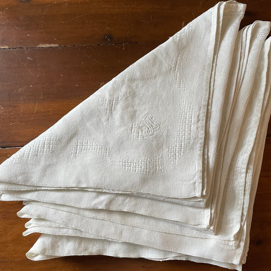Stack of white napkins on a wooden surface