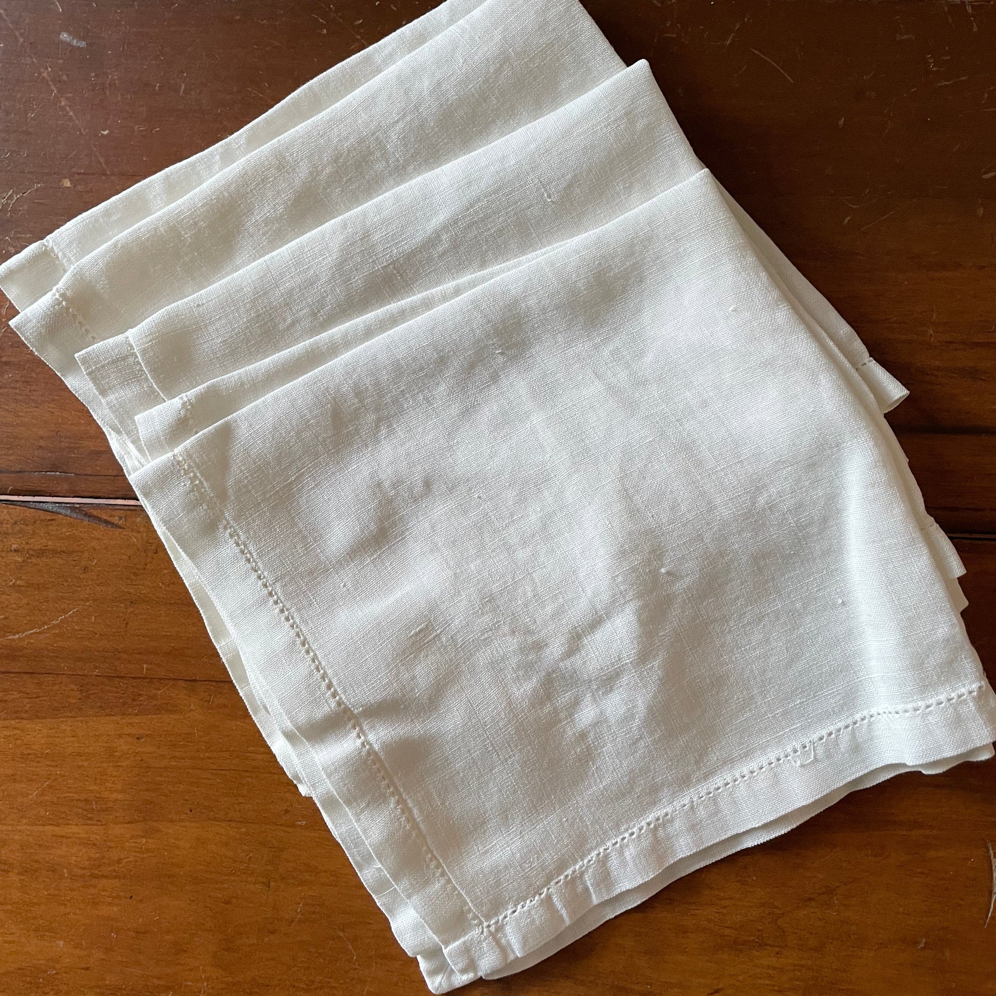 Folded white cloth on a wooden surface