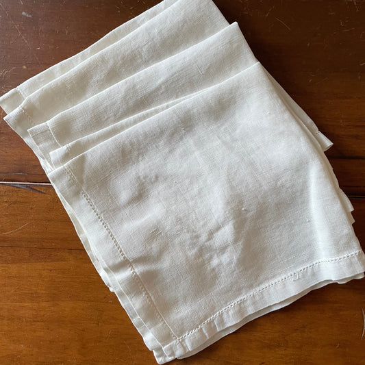 Folded white cloth on a wooden surface