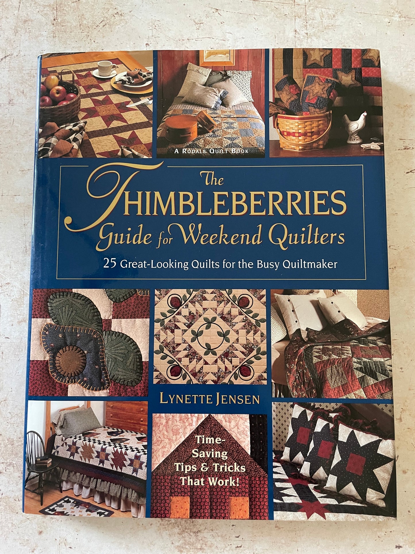 A quilting book cover with a grid of muted earth tone quilts