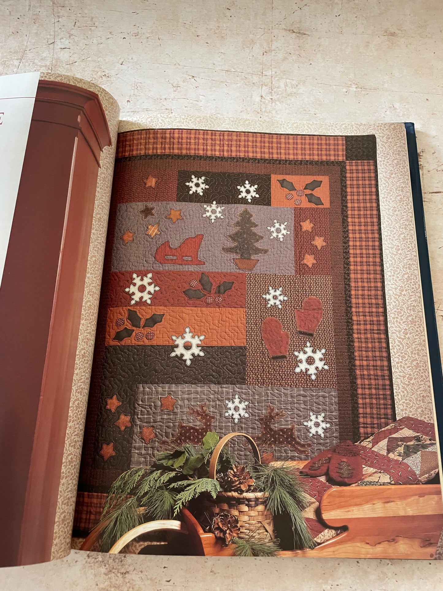 a winter themed quilt in warm brown and red colors