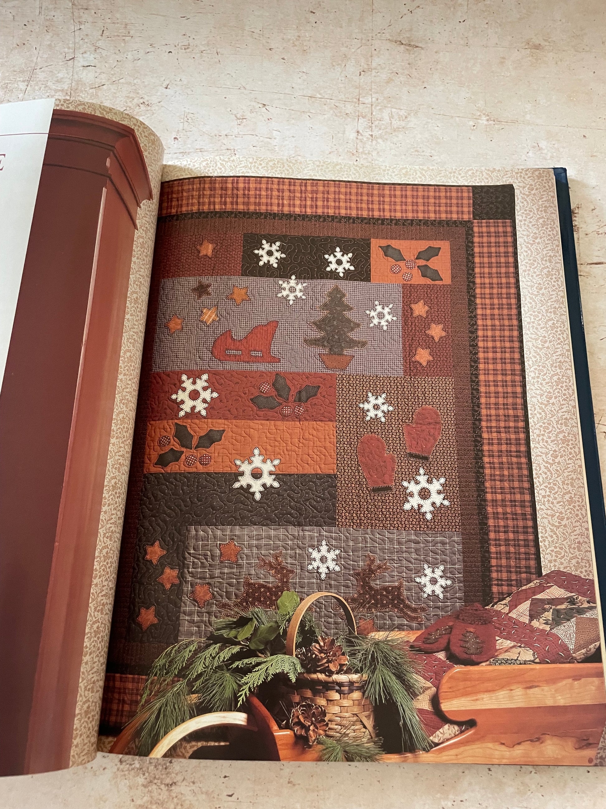  a winter themed quilt in warm brown and red colors