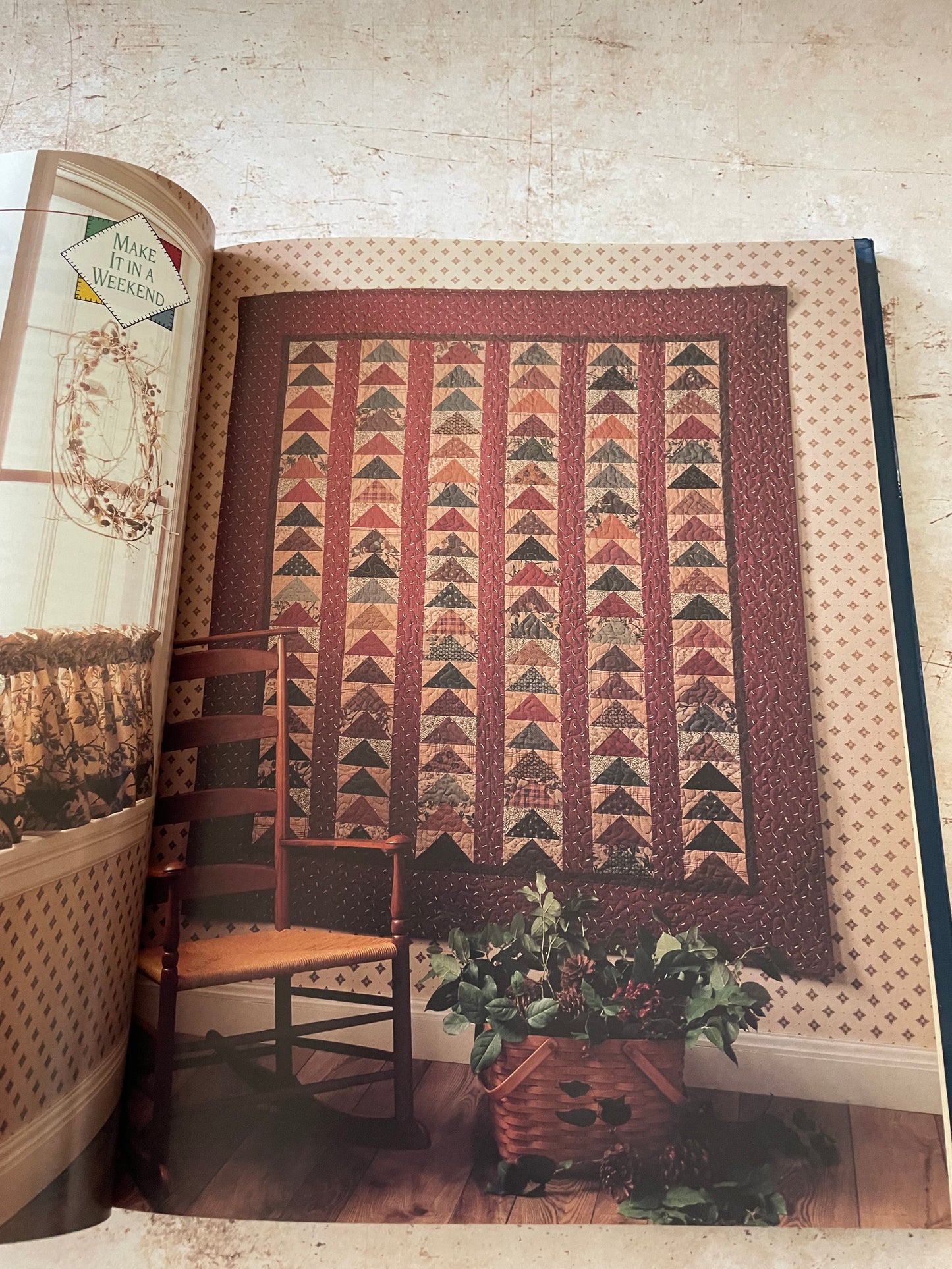 a flying geese quilt in earthy reds and browns
