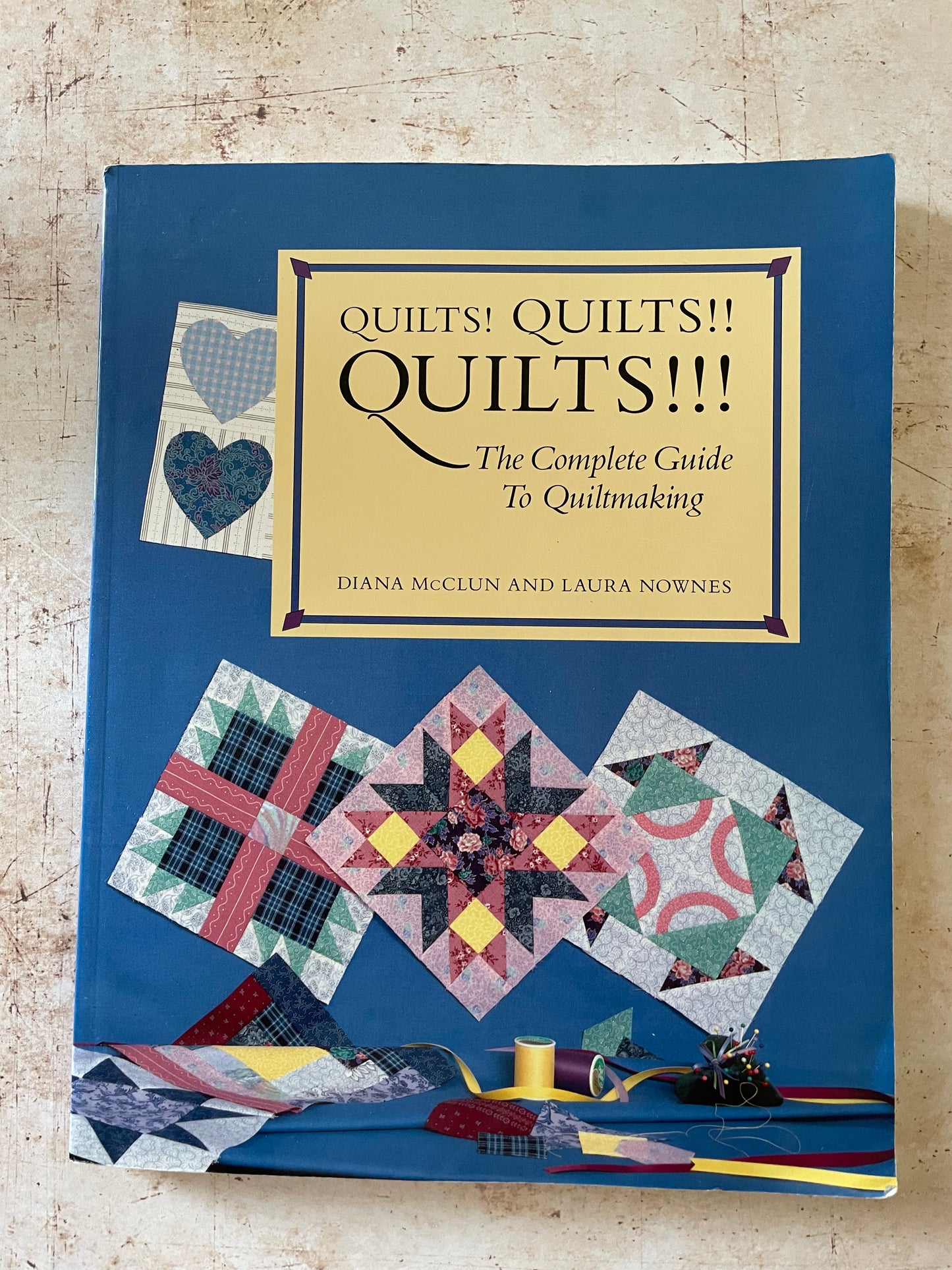 A blue book cover with quilt block samples