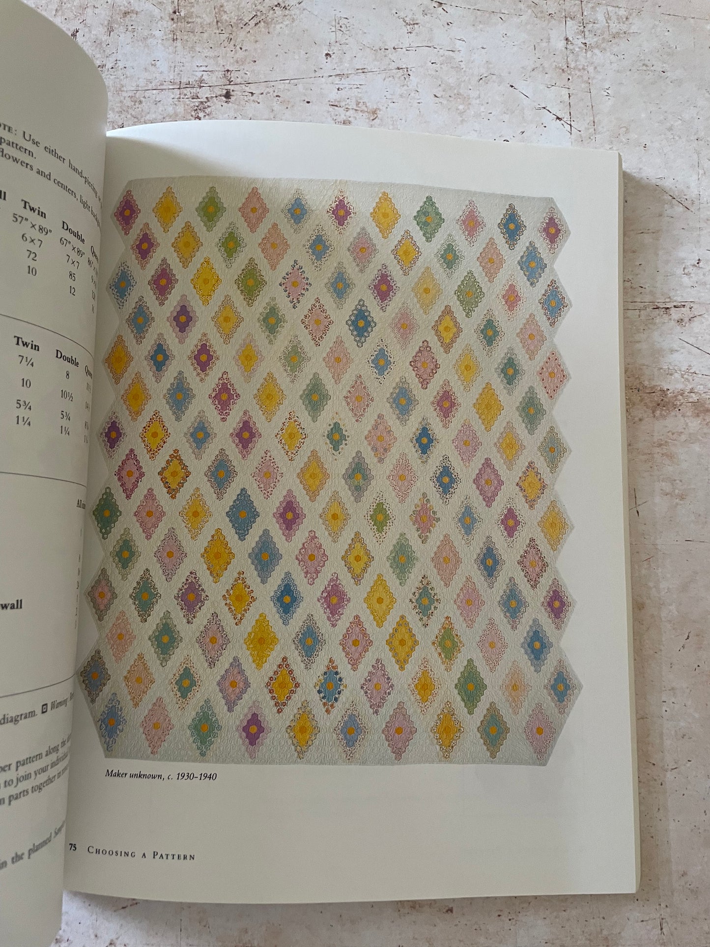 a quilt made of tiny hexagons in pastel diamond shapes