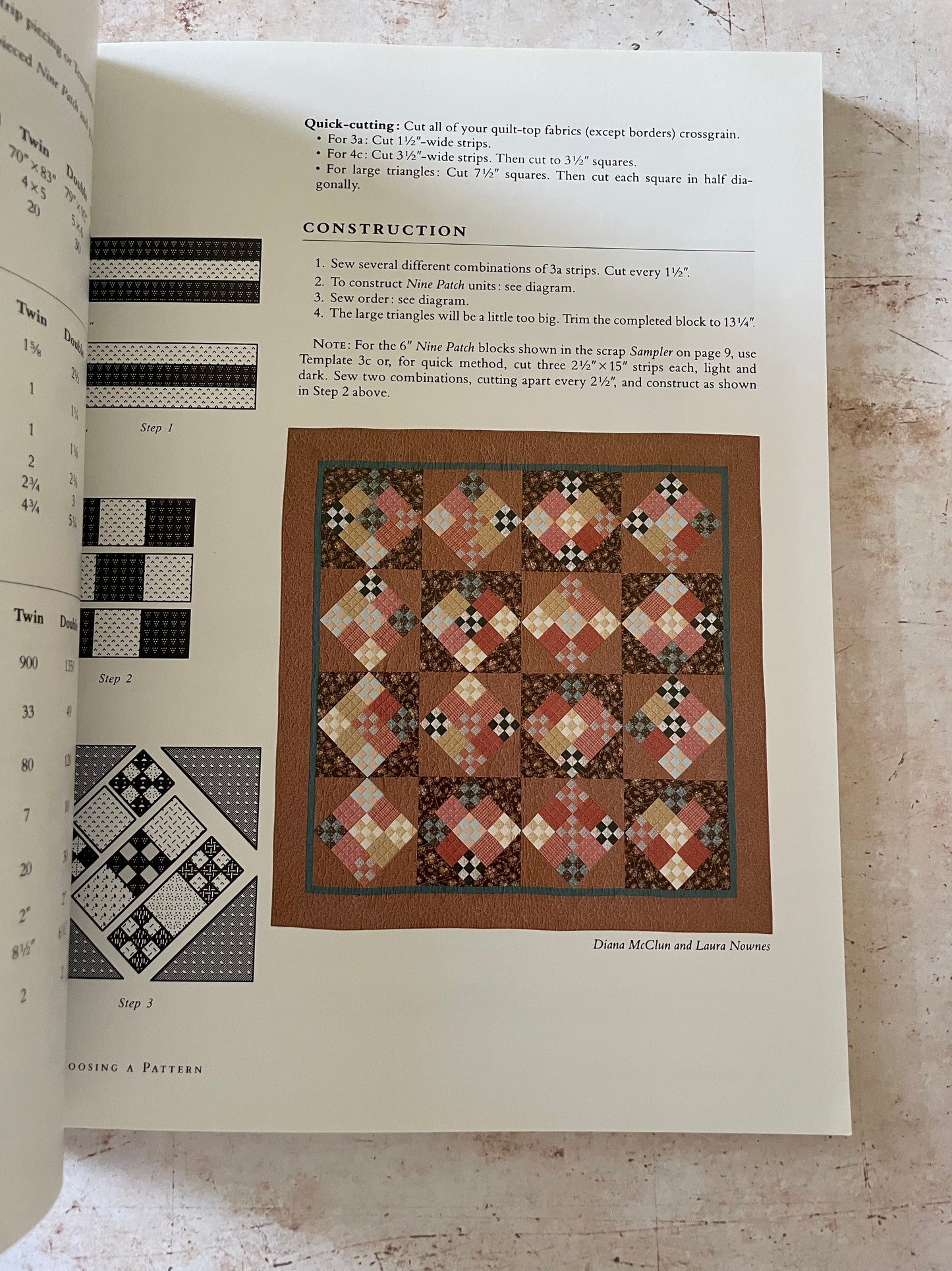 a brown quilt made of small nine patch blocks