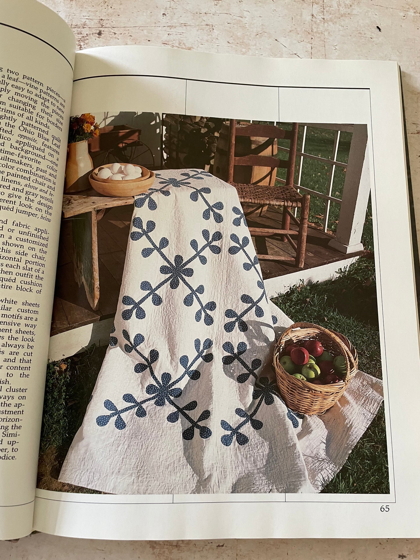 a quilt with a blue flower vine on a white background