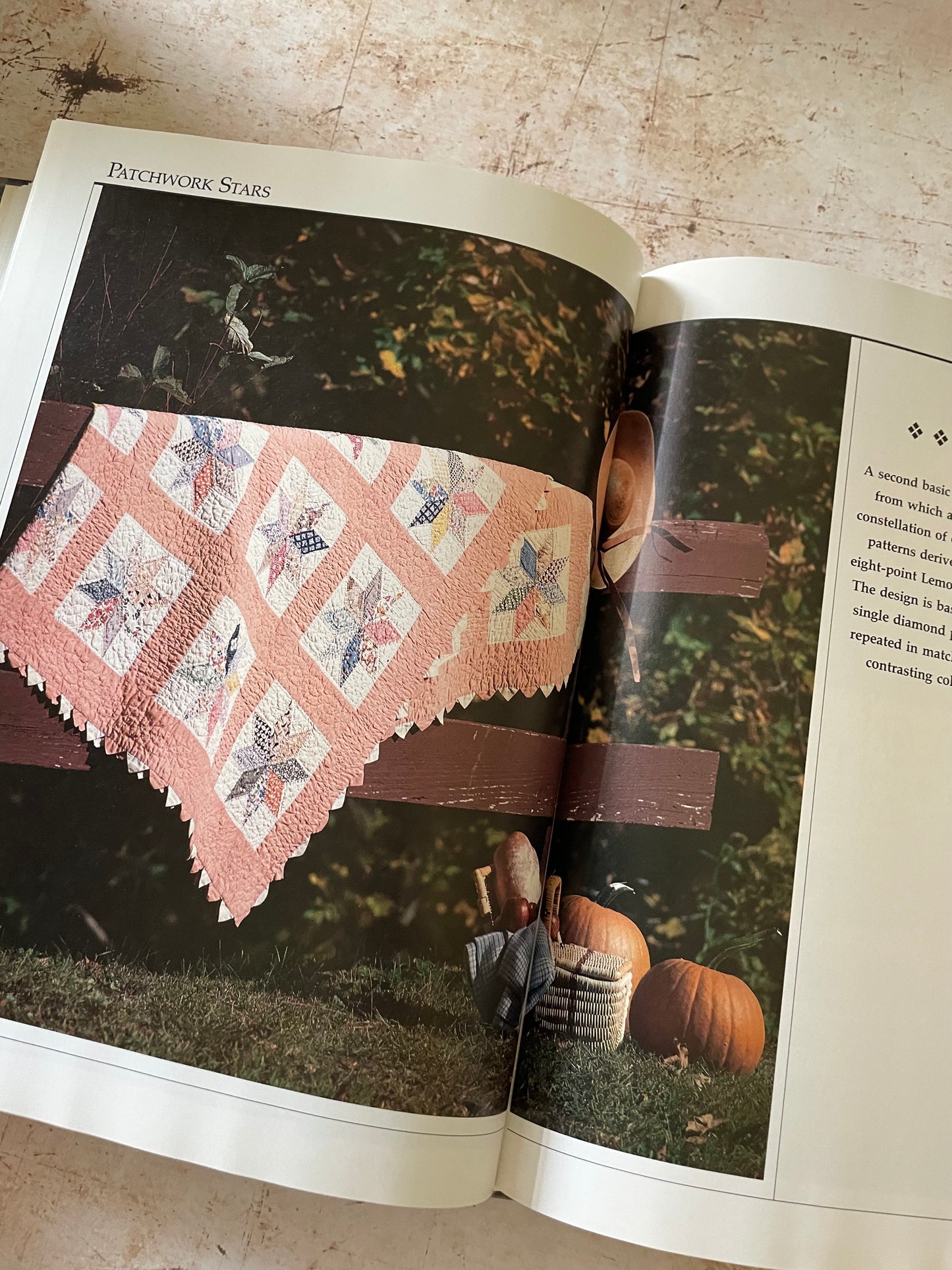 a vintage looking quilt with stars in pastel and peach colors