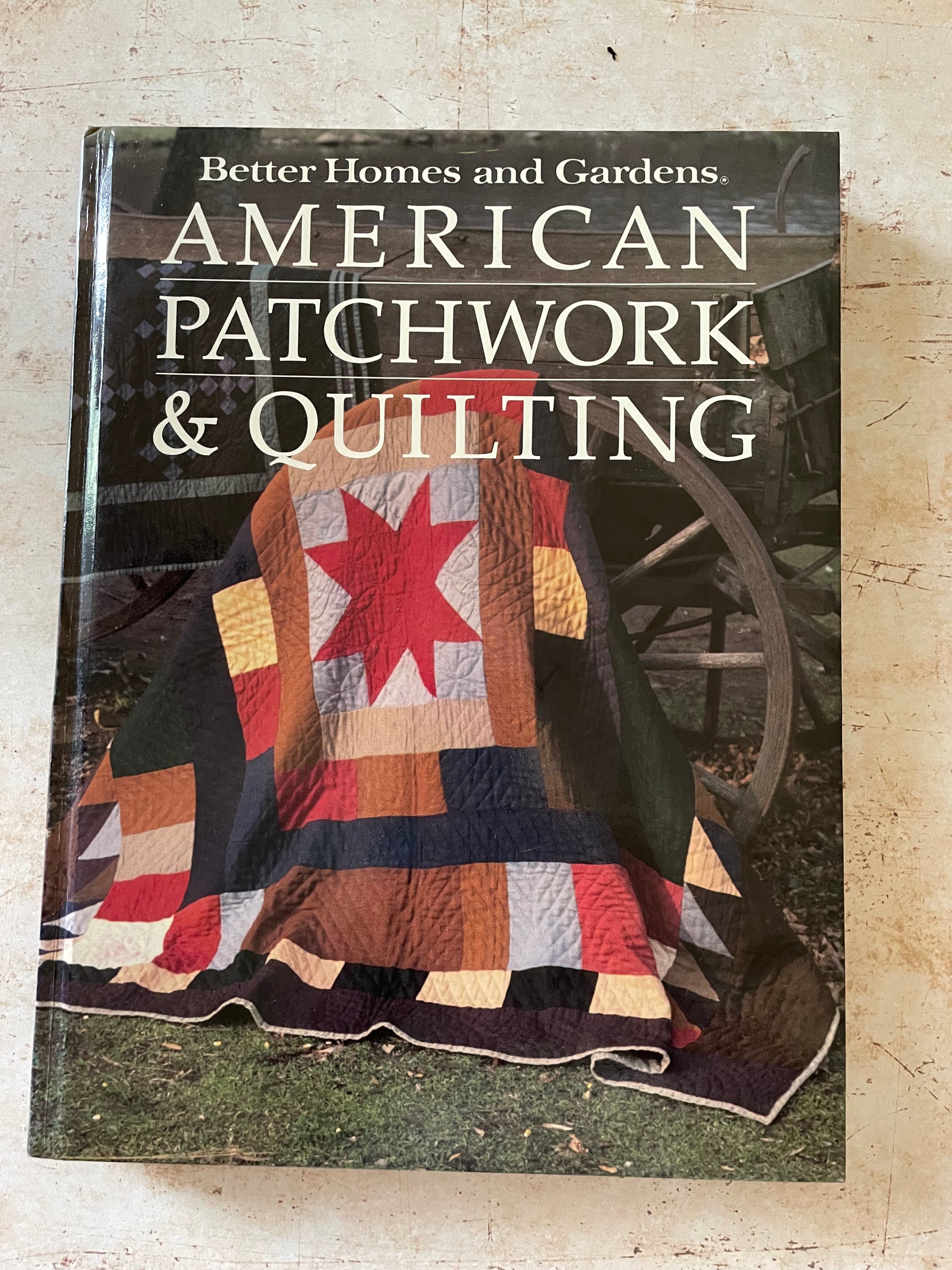 a book cover with a quilt with a red star