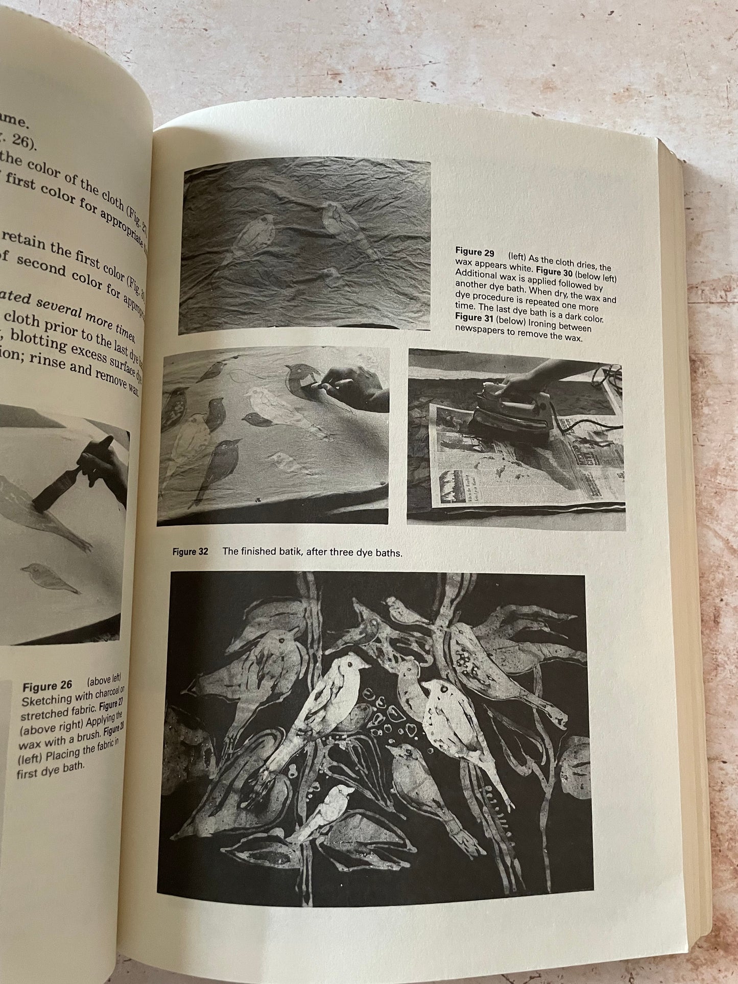 An open vintage book showing printed figures, diagrams, and black-and-white artwork on cream paper.