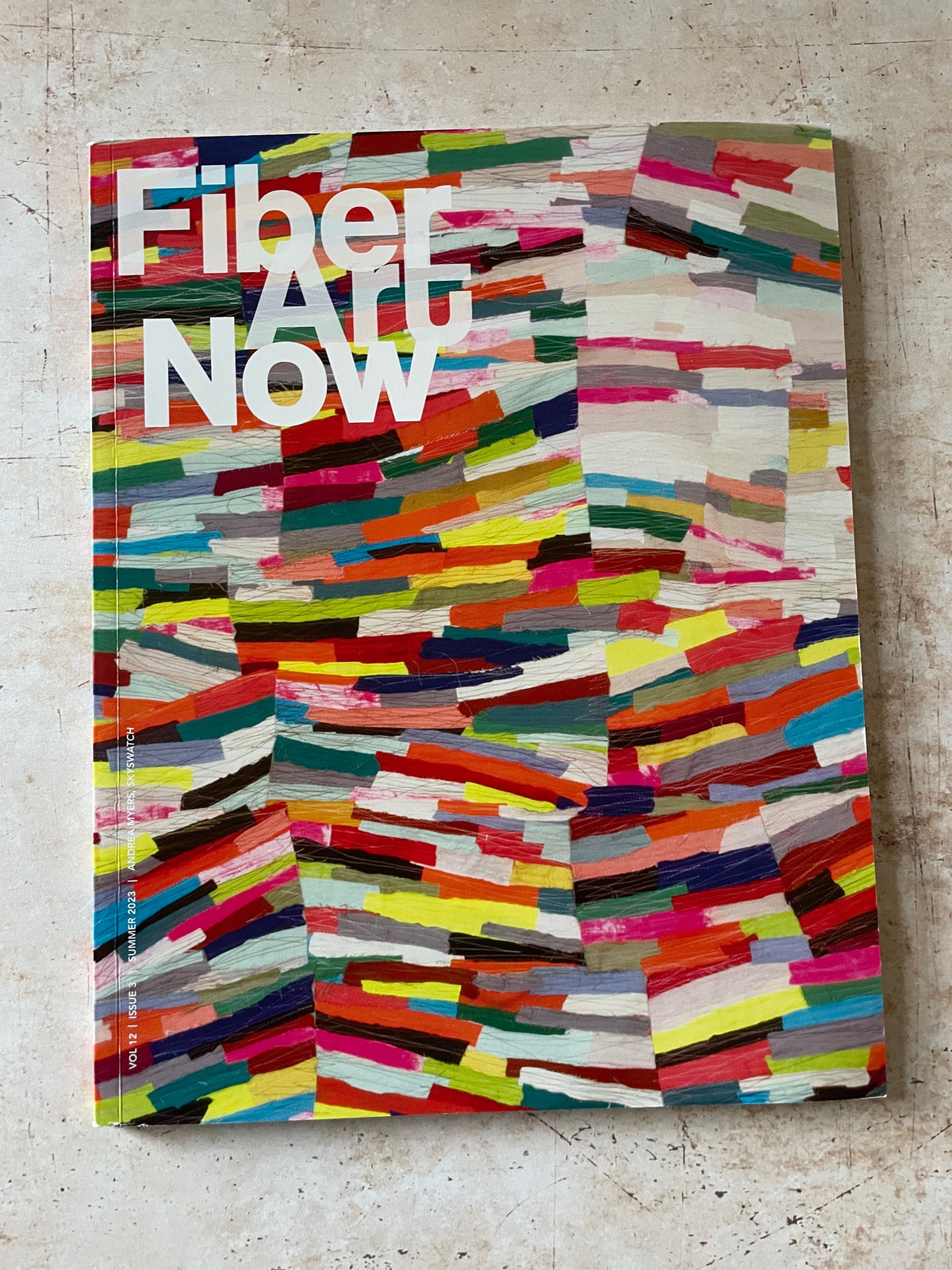 bright colorful brushstrokes on a magazine cover of Fiber Art Now