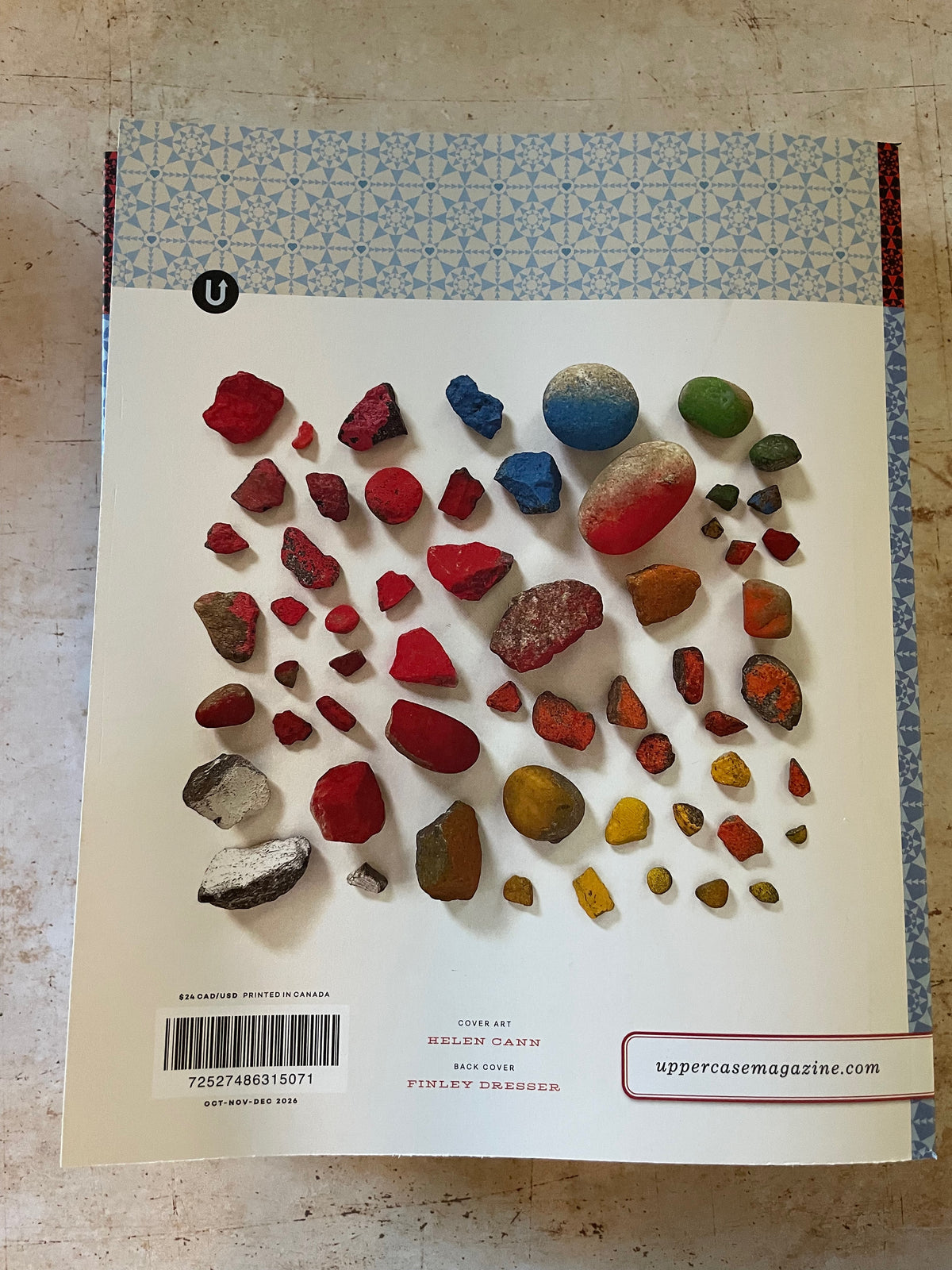 the back cover of a magazine showing a collection of painted rocks