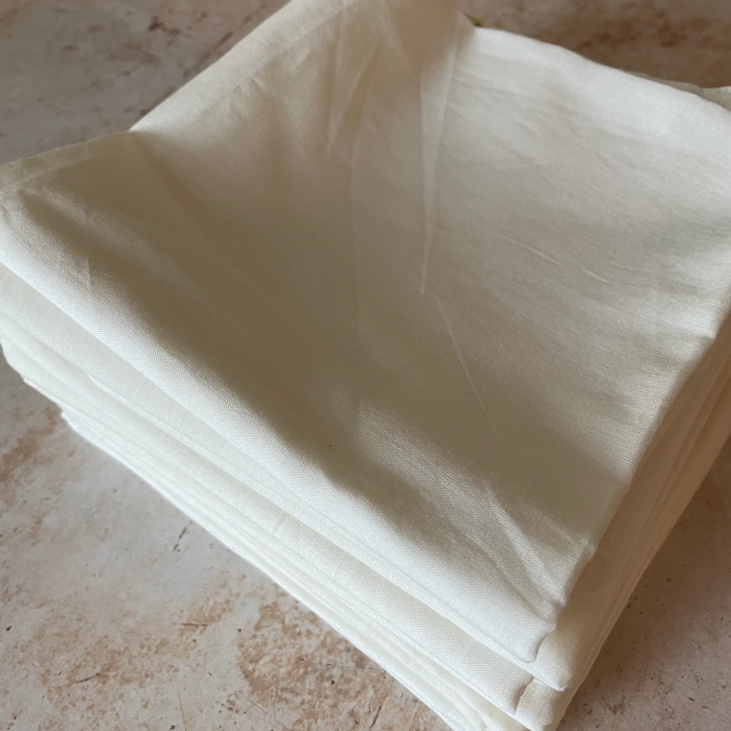 a stack of natural cotton bandanas 