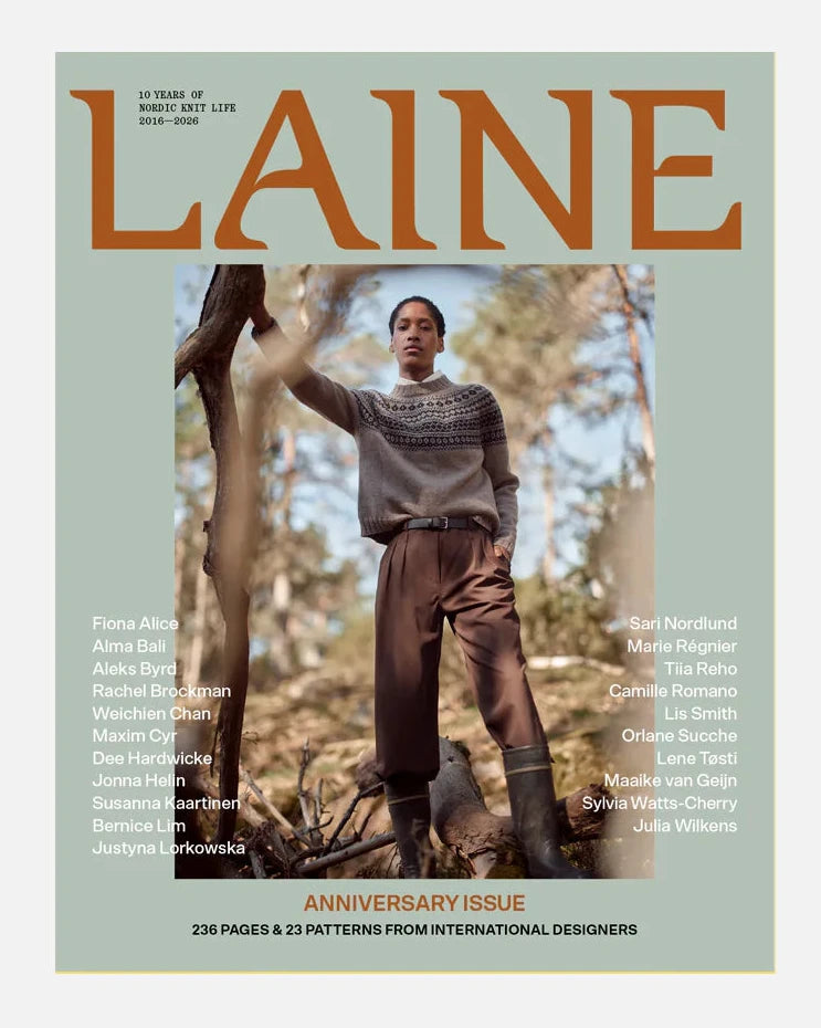 Magazine cover with a person in a forest, featuring the brand 'Laine'.