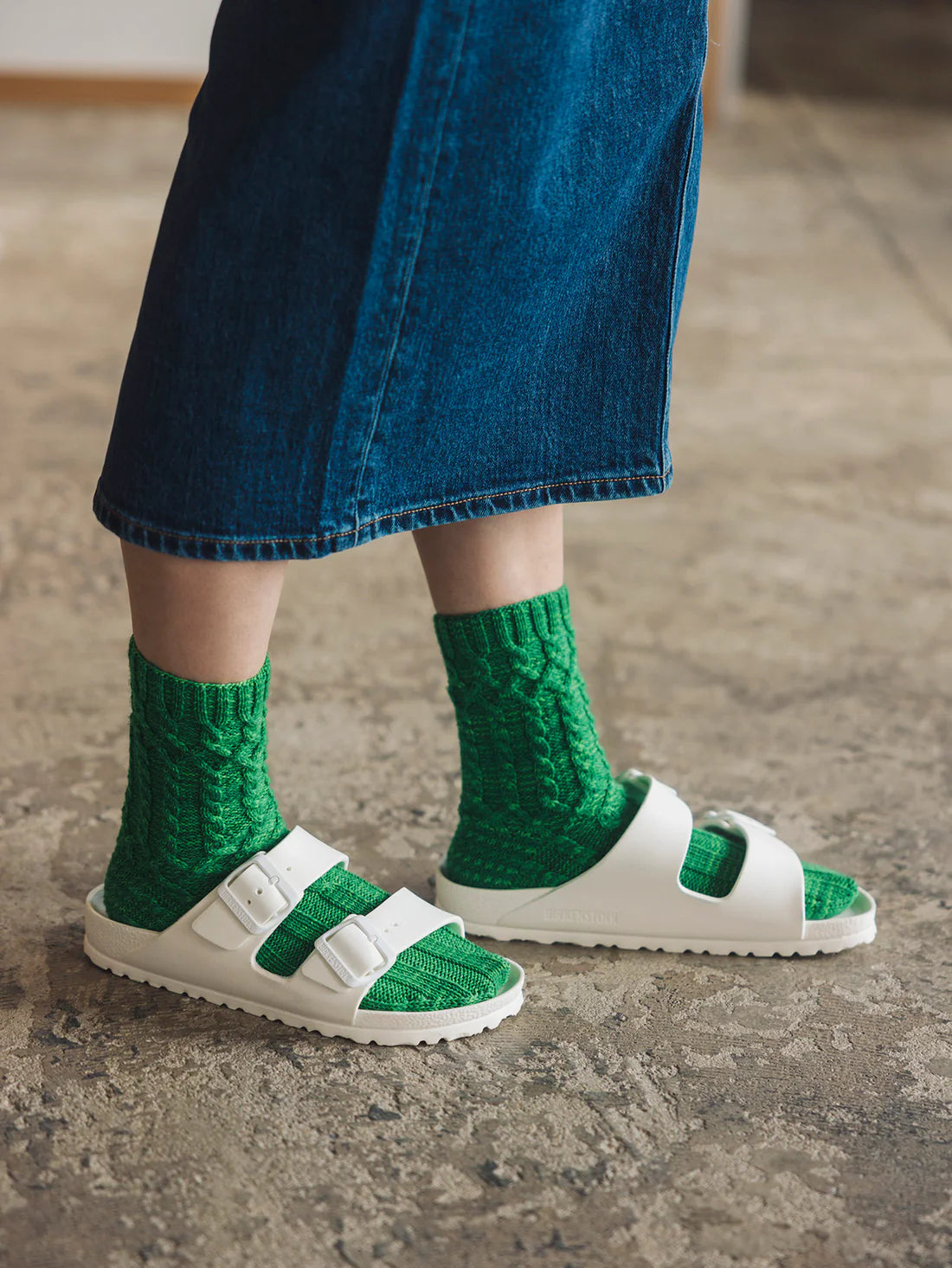 a pair of green cabled knitted socks