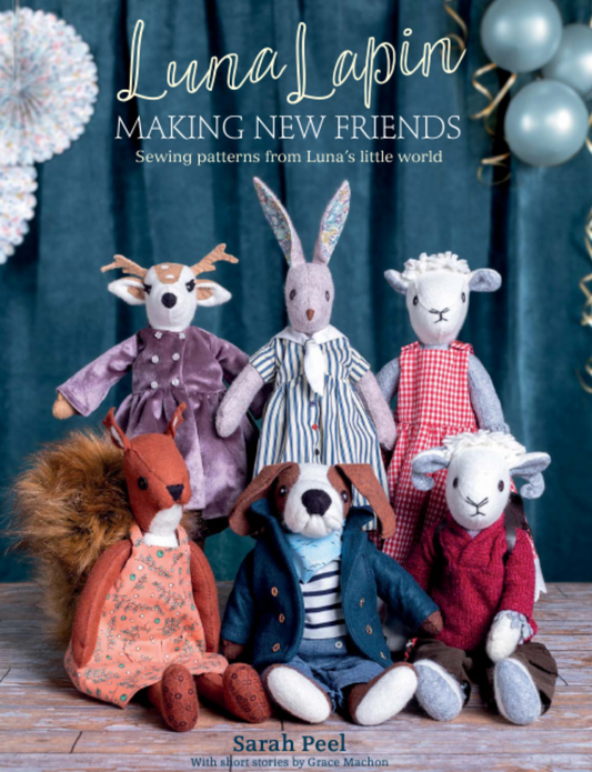 Book cover of 'Luna Lapin: Making New Friends' featuring stuffed animals against a dark curtain background.