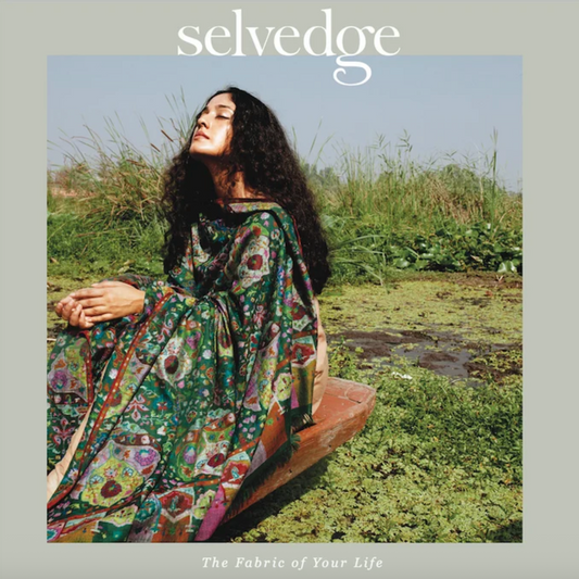 a magazine cover with a women sitting in a wooden boat wearing a green floral robe