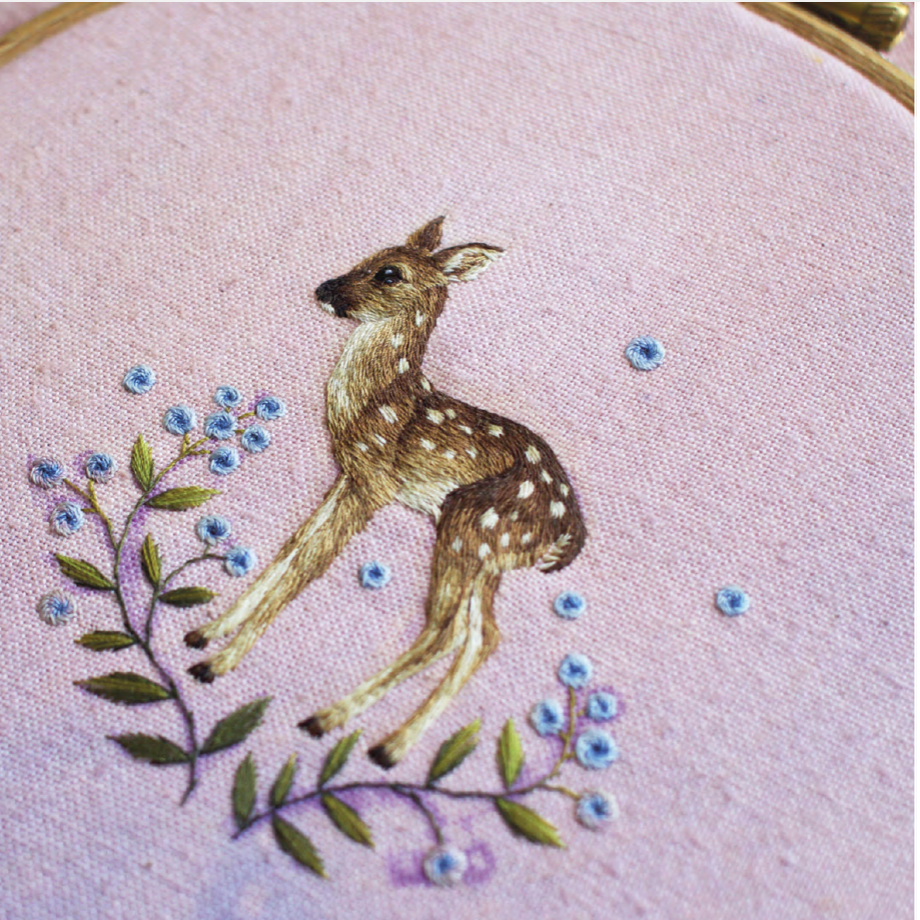 Fawn embroidery on a pink cloth