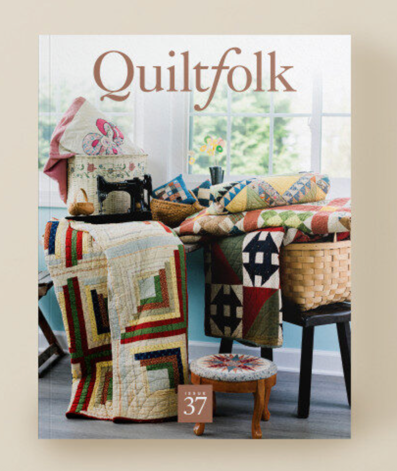 Cover of 'Quiltfolk' magazine featuring quilts and a sewing machine on a table.