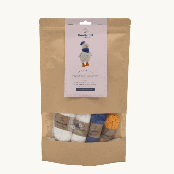 Kraft paper packaging with a label showing a design of a crochet kit