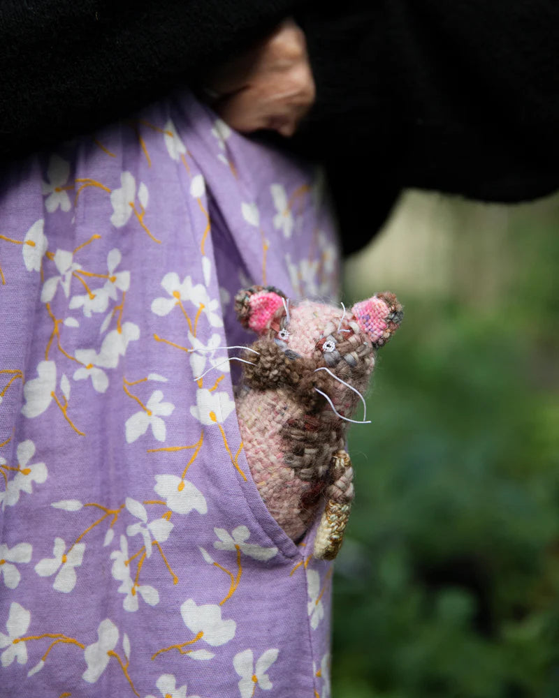 a brown animal with pink ears