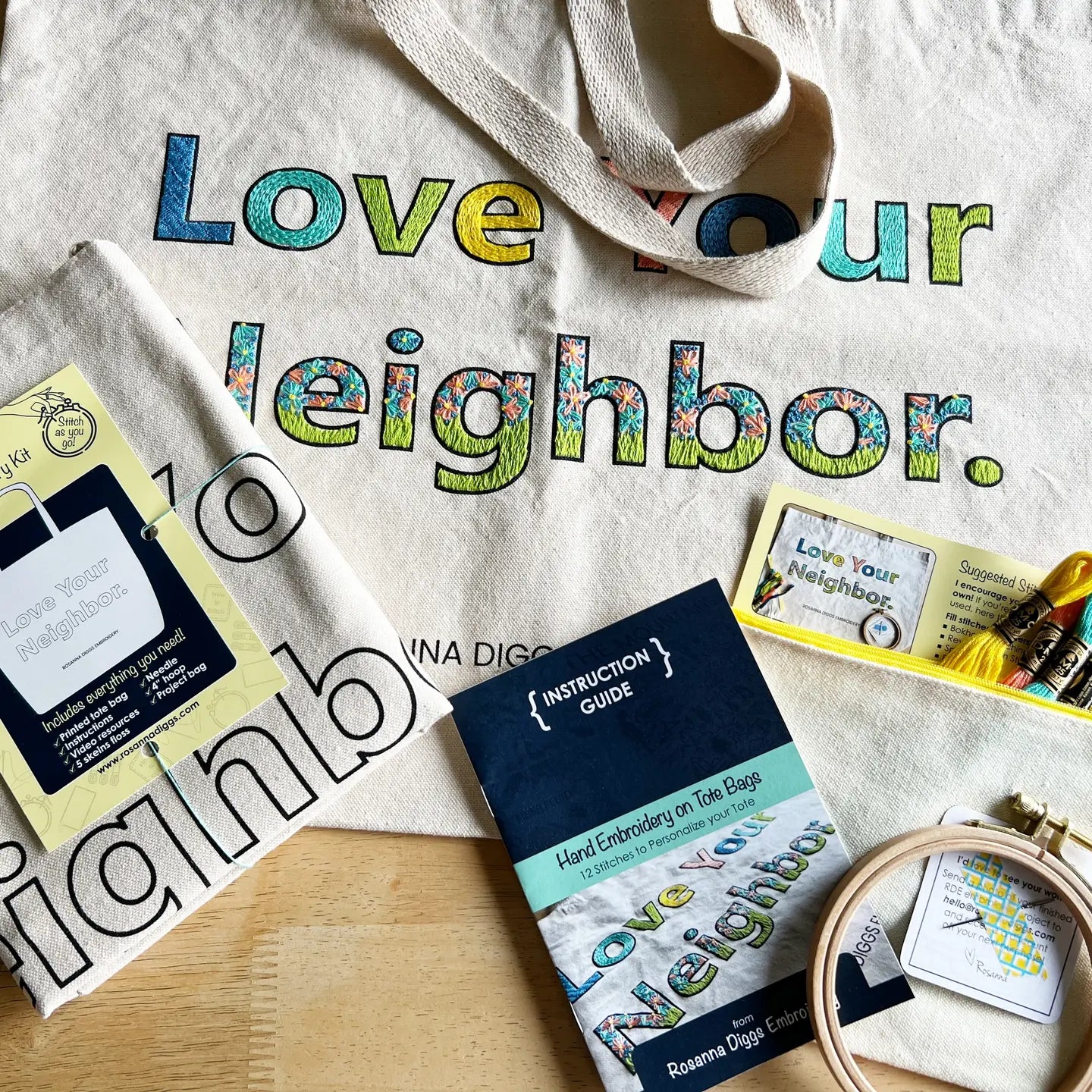 Embroidery kit with 'Love your neighbor' text on a fabric background