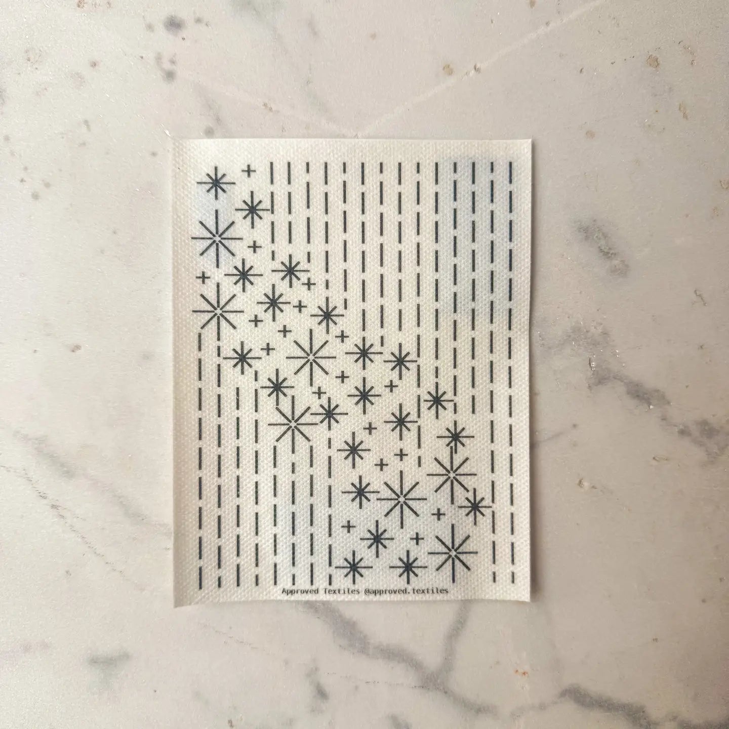Patterned paper with geometric star design on a marble surface