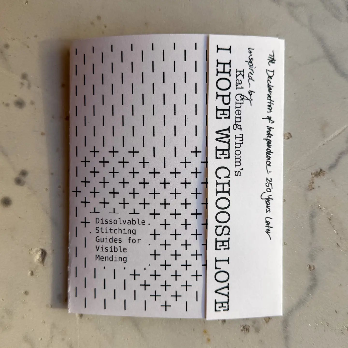Booklet with text and patterns on a textured surface