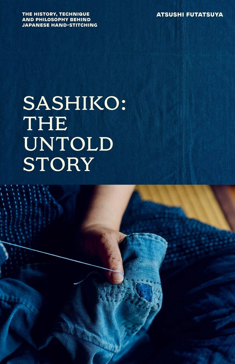 a blue book cover with a person doing sashiko stitching