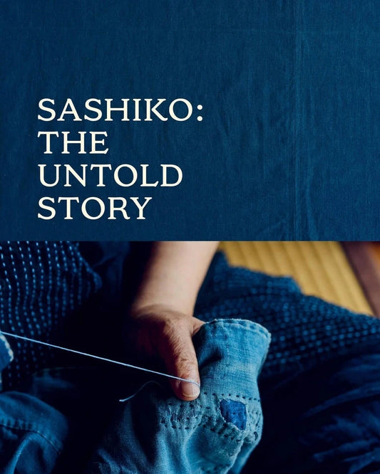 a blue book cover with a person doing sashiko stitching