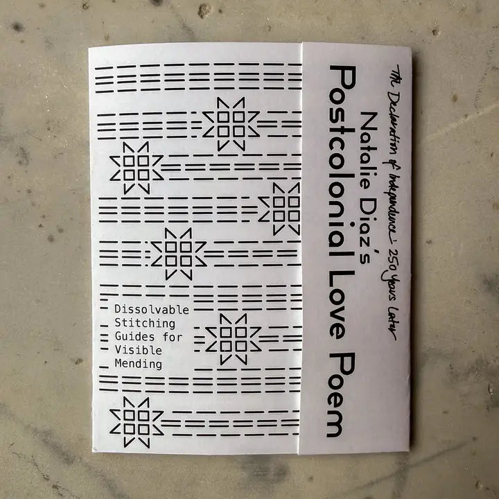 Booklet with text and patterns on a textured surface