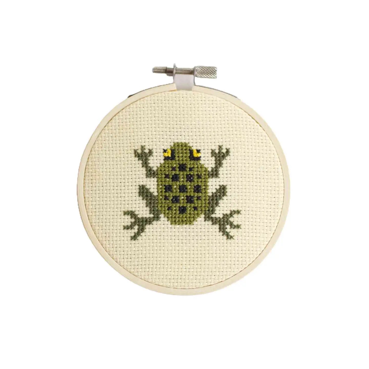 a cross stitch frog design in an embroidery hoop