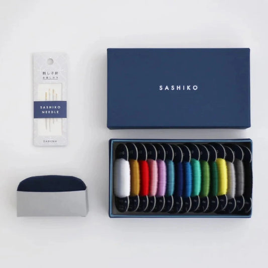a blue box with sashiko threads and needles