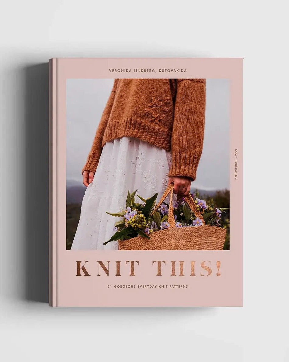 A hand knit sweater with a woven basket of flowers