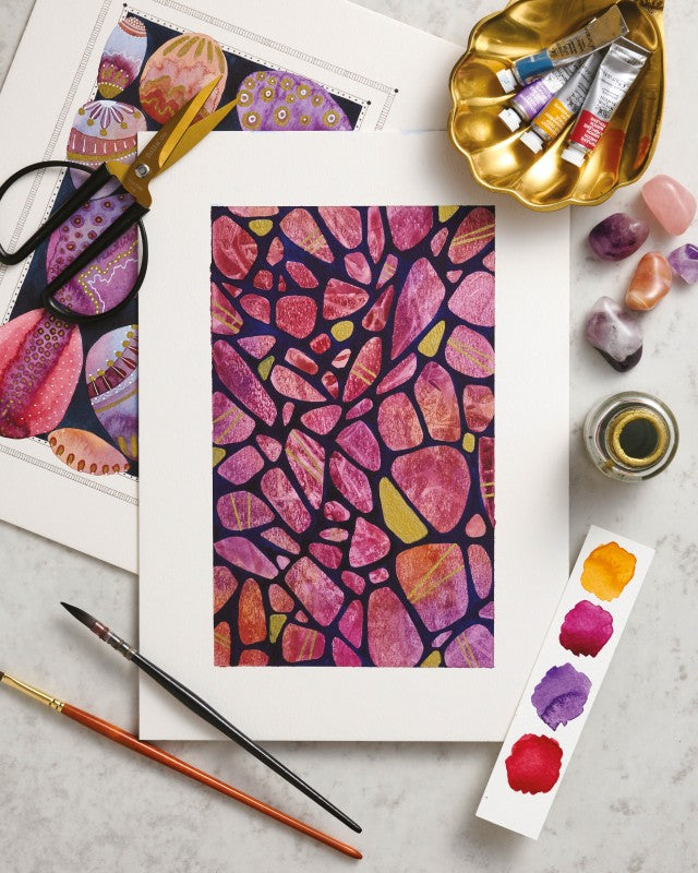 Colorful abstract art with painting supplies on a light gray surface