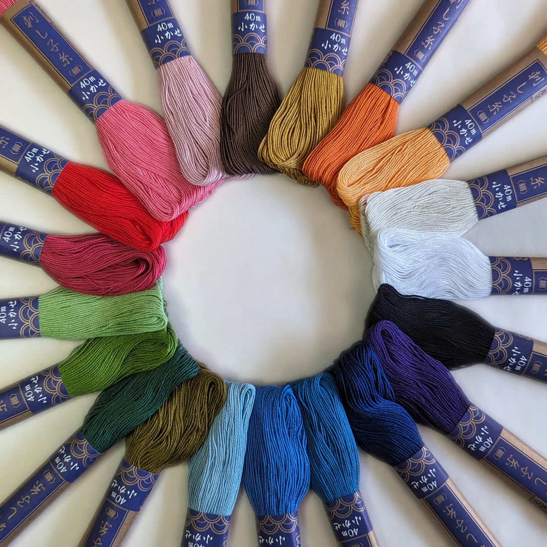 a circle of rainbow colored sashiko embroidery floss