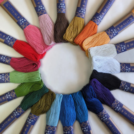 a circle of rainbow colored sashiko embroidery floss