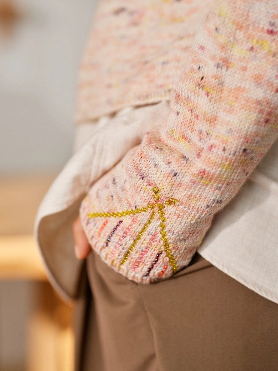 Close-up of a textured fabric with colorful patterns on a blurred background