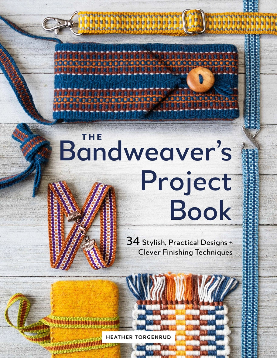 Book titled 'The Bandweaver's Project Book' with woven bands on a wooden surface.
