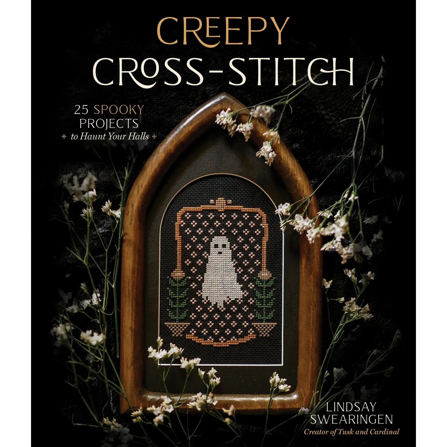 Book cover of 'Creepy Cross-Stitch' with a cross-stitched ghost design and wooden frame.